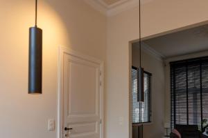 a room with two lights and a door and a mirror at APL8 St-Anna B&B in Bruges