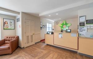 a waiting room with a chair and a counter at Extended Stay America Suites - Norfolk - Virginia Beach in Virginia Beach