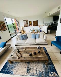 a living room with a couch and a table at Vista Lapas Nativa Resort in Jacó