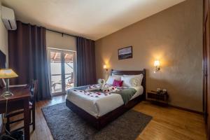 a bedroom with a bed with a stuffed animal on it at Hotel Vista Bela do Gerês in Outeiro