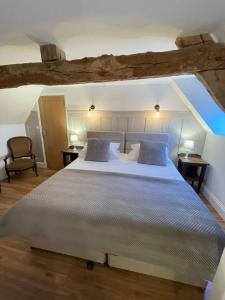 a bedroom with a large bed with blue pillows at Frenes B&B in Frênes
