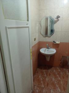 a bathroom with a sink and a mirror at خالد بن الوليد بجوار كشرى التحرير in Alexandria