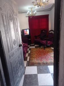 a door leading to a living room with a red curtain at خالد بن الوليد بجوار كشرى التحرير in Alexandria