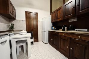 a kitchen with wooden cabinets and a white counter top at Da Mario in Florence Guesthouse in Florence +19 photos