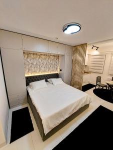 a bedroom with a large white bed in a room at A'dors Apartments in Skopje