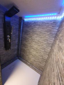 a shower with blue lights in a room at Nephelin in Weil am Rhein