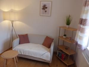 ein kleines Wohnzimmer mit einem Sofa und einem Tisch in der Unterkunft Ferienwohnungen Reitinger in Tiefenbach