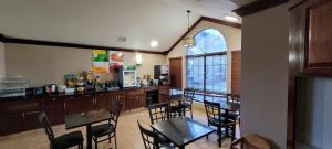 a restaurant with a table and chairs and a kitchen at Quality Inn & Suites Columbia I-70 in Columbia