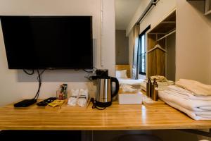 a desk with a television on top of it at Royce Boutique Betong in Betong