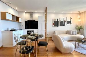 a living room with a table and a couch at The Panorama of Marina - AppartAli in Casablanca