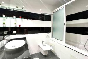 a white bathroom with a sink and a toilet at The Panorama of Marina - AppartAli in Casablanca +50 photos
