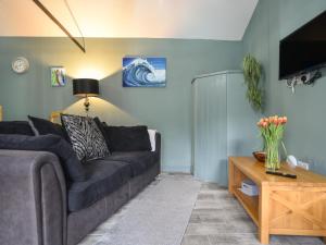 a living room with a couch and a table at Sunnyside at Coomb Bank Farm in Axminster