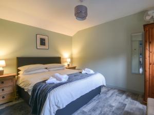 a bedroom with a bed with towels on it at Sunnyside at Coomb Bank Farm in Axminster