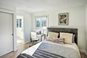 a bedroom with a bed and a desk with a chair at Lakefront Otis Home with Stunning Views and Boats! in Otis