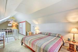 a bedroom with a bed and a table with two lamps at Charming Eugene Vacation Home 1 Mi to Dtwn! in Eugene