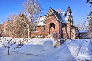a brick house with snow on the ground at Convenient Denver Home with Private Hot Tub! in Denver
