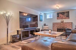 a living room with a couch and a fireplace at Convenient Denver Home with Private Hot Tub! in Denver