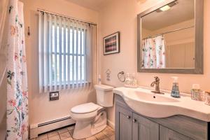 a bathroom with a sink and a toilet and a mirror at Westerly Vacation Home: Town Beach Access in Westerly +18 photos
