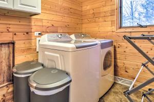 a washer and dryer in a log cabin at Crandon Cabin Getaway with Boat Dock and Deck! in Crandon