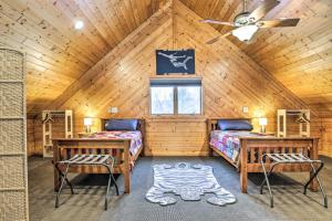 a bedroom with two beds and two chairs in a cabin at Crandon Cabin Getaway with Boat Dock and Deck! in Crandon