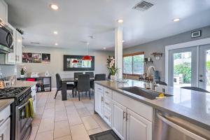 a kitchen with a sink and a counter top at Sunny Santa Ana Rental Home Near Disneyland! in Santa Ana