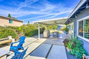 a patio with two blue chairs and a table at Sunny Santa Ana Rental Home Near Disneyland! in Santa Ana