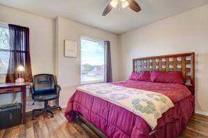 a bedroom with a bed and a desk and a chair at Family Home with Sunroom and Fire Pit! in New Braunfels +24 photos