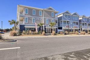 a row of houses on a street with palm trees at Gorgeous Emerald Isle Getaway Walk to Beach! in Emerald Isle
