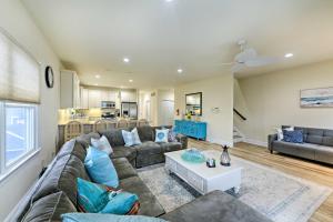 a living room with a couch and a table at Sunny Brigantine Townhome Walk to Beach in Brigantine +24 photos