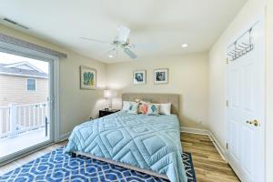 a bedroom with a bed and a balcony at Sunny Brigantine Townhome Walk to Beach in Brigantine