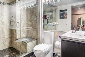 a bathroom with a shower and a toilet and a sink at Waterfront Cleveland Apt about 1 Mi to Downtown in Cleveland