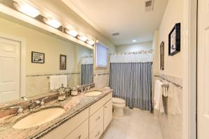 a bathroom with two sinks and a large mirror at Sunny Brigantine Townhome Walk to Beach in Brigantine