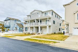 a large white house with a balcony on a street at Sunny Brigantine Townhome Walk to Beach in Brigantine