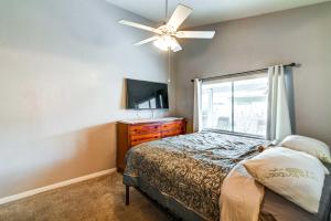 Schlafzimmer mit einem Bett, einer Kommode und einem Deckenventilator in der Unterkunft Southwest Ranch House - 12 Mi to Vegas Strip in Las Vegas