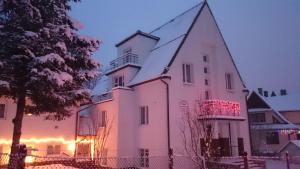 a large white building with a clock tower at Pokoje Gościnne Żak in Zakopane