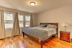 a bedroom with a bed and two windows at Newark Apt about 5 Mi to Museums and Art Centers! in Newark