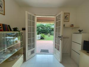 a room with a door open to a yard at Relax in Piscina - Free Parking e ampio Giardino in Loano