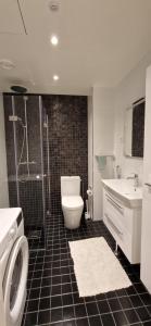 a bathroom with a toilet and a shower and a sink at Sea & City view Home near Nature in Helsinki +11 photos