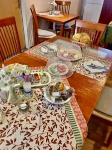 a wooden table with plates of food on it at Penzion Sport in Gaming