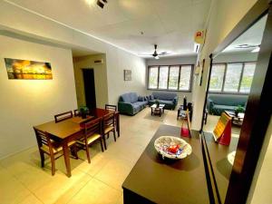 a living room with a table and a dining room at Relax Home 4-8 Pax Sunway Lagoon & Sunway Pyramid in Kampong Penaga
