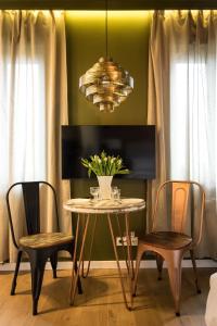 a dining room with a table and two chairs at Uniejów Apartments in Uniejow