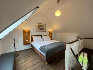 a bedroom with a bed in a attic with a staircase at Ferienhof Bludnik in Kaupen