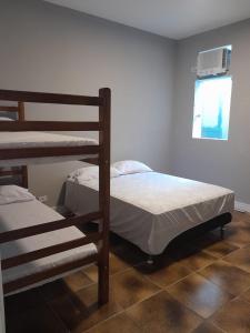 Ένα ή περισσότερα κρεβάτια σε δωμάτιο στο POUSADA VILLA DI GUARUJÁ