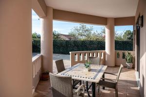a patio with a table and chairs on a porch at Villa Fanouris in Chania