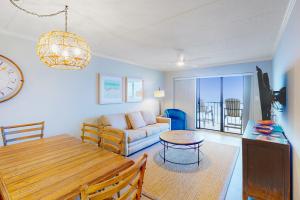 a living room with a table and a couch at Summer Beach 602 in Ocean City