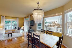 a dining room with a table and a chandelier at Bay View Retreat in Eastsound