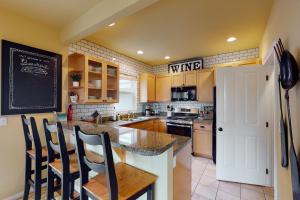 a kitchen with a table and a blackboard on the wall at Bay View Retreat in Eastsound
