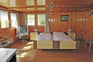 a bedroom with a bed and a tv in it at Chalet Talblick in Saas-Grund