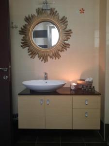 a bathroom with a sink and a mirror on the wall at Phivos Home & Garden in Messini