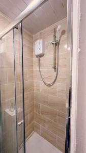 a shower with a glass door in a bathroom at The Dacy - By Chaps in Liverpool